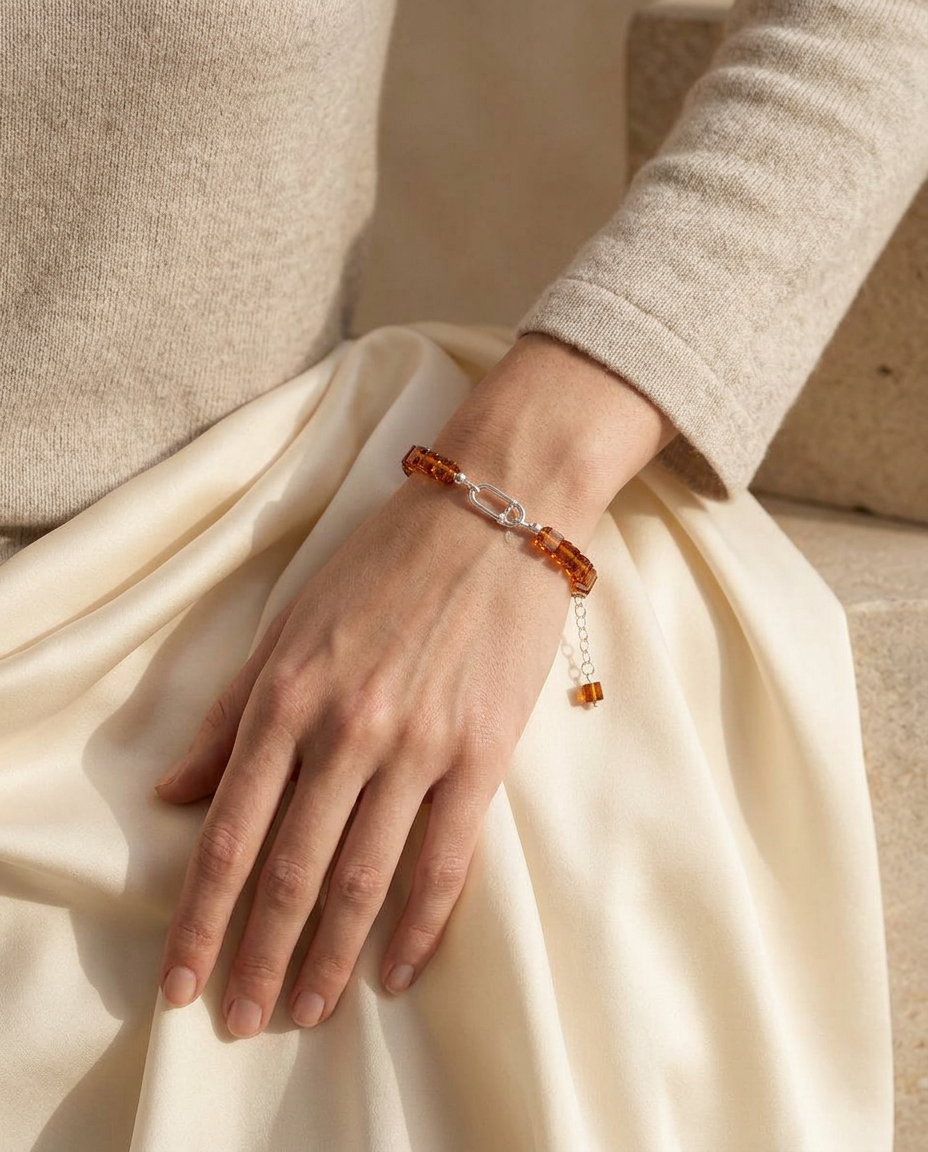 Model wearing the AMBREA cognac honey amber cube bracelet