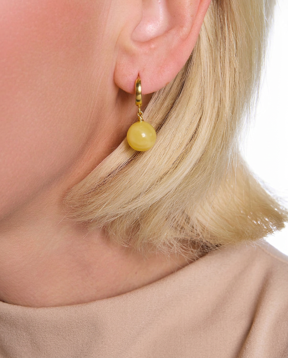 Model wearing AMBREA royal Baltic amber drop earrings